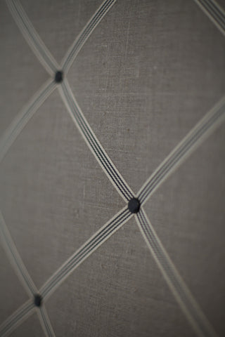 A notice board covered with French natural linen and cream/black narrow stripes ribbons